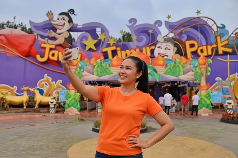 (Ilustrasi seseorang traveling di Jatim Park, Sumber: AI Google Gemini)